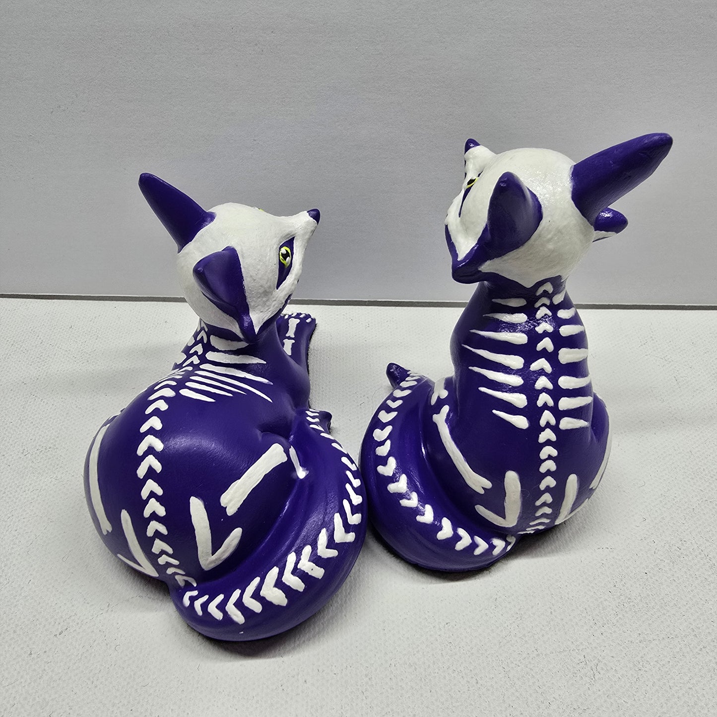 back of purple fox pup (kit) figures showing a heart shaped, herringbone Skeleton design