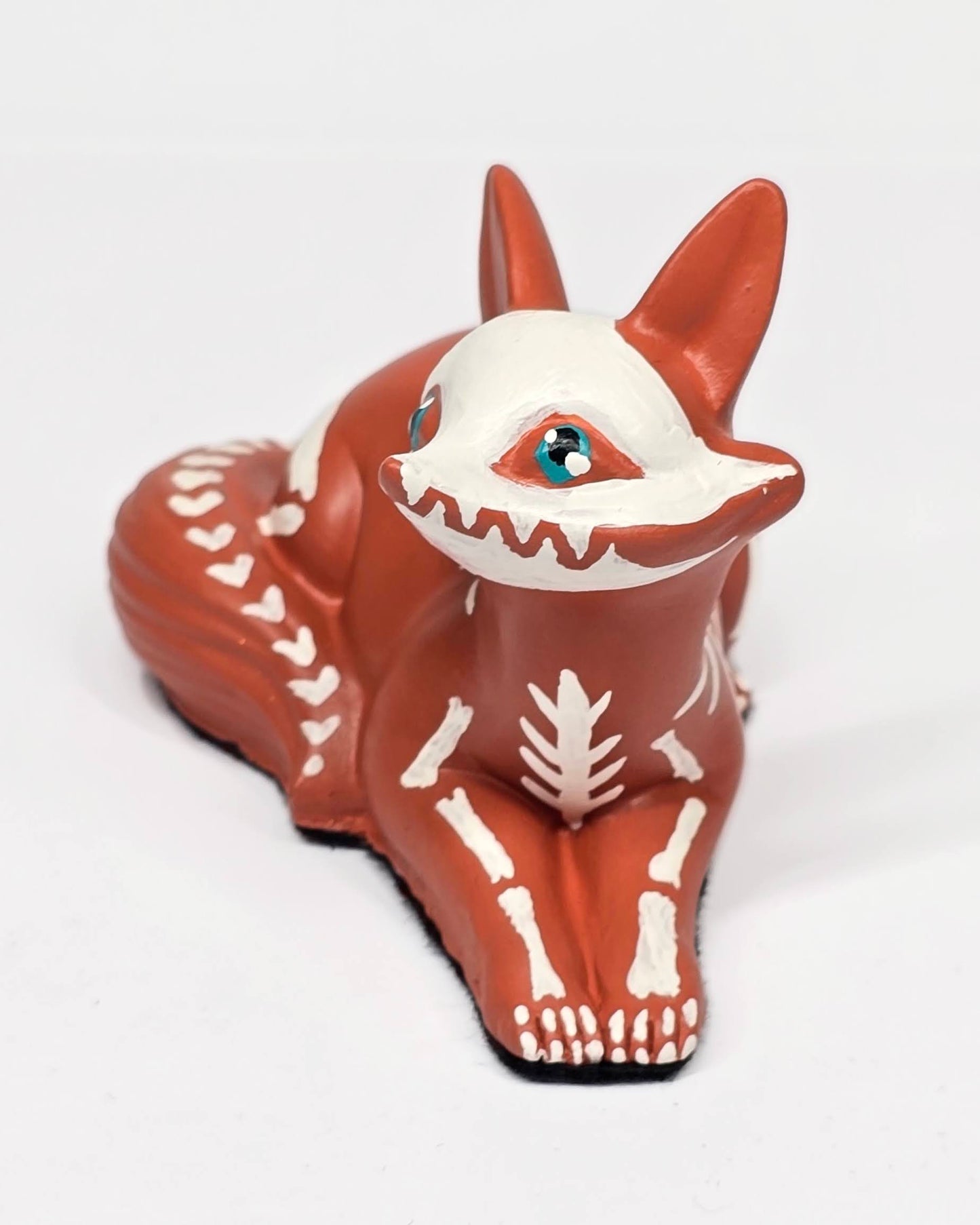 Sculpture of a fox with a skeleton design on a white background