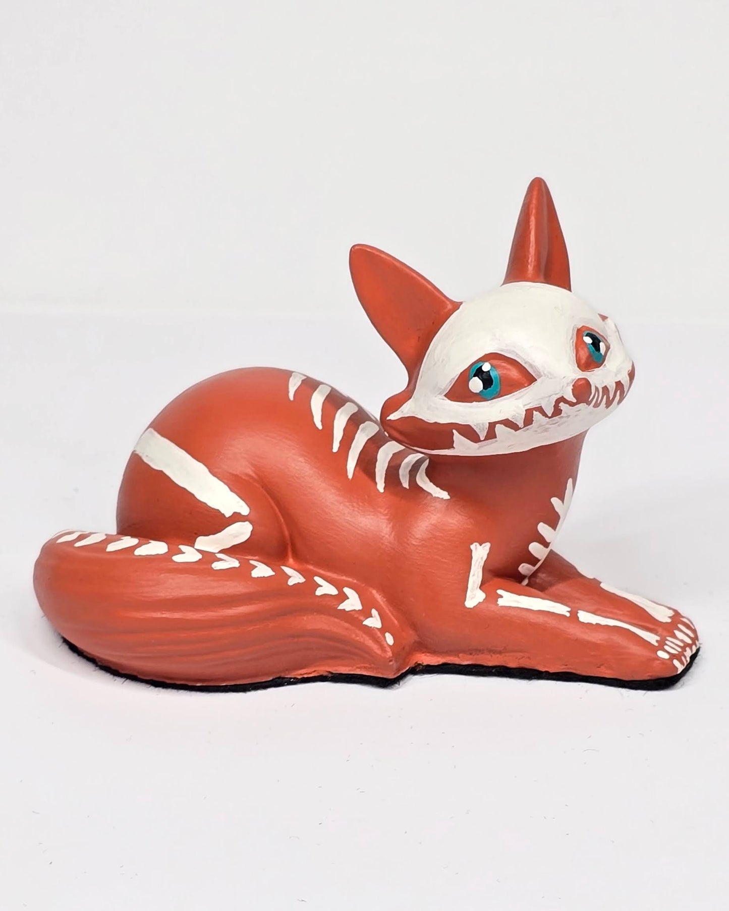 Sculpture of a fox with a skeleton design on a white background
