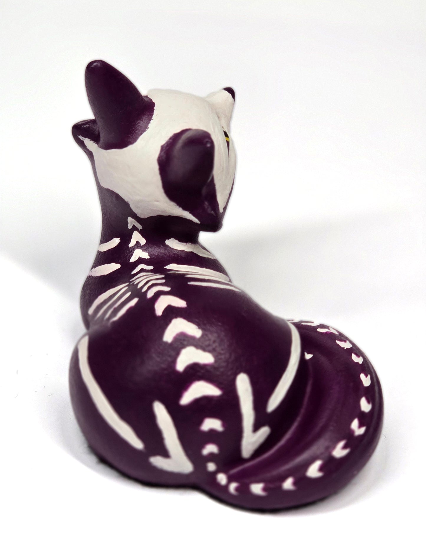 Purple and white puppy-shaped figures with skeleton bone markings