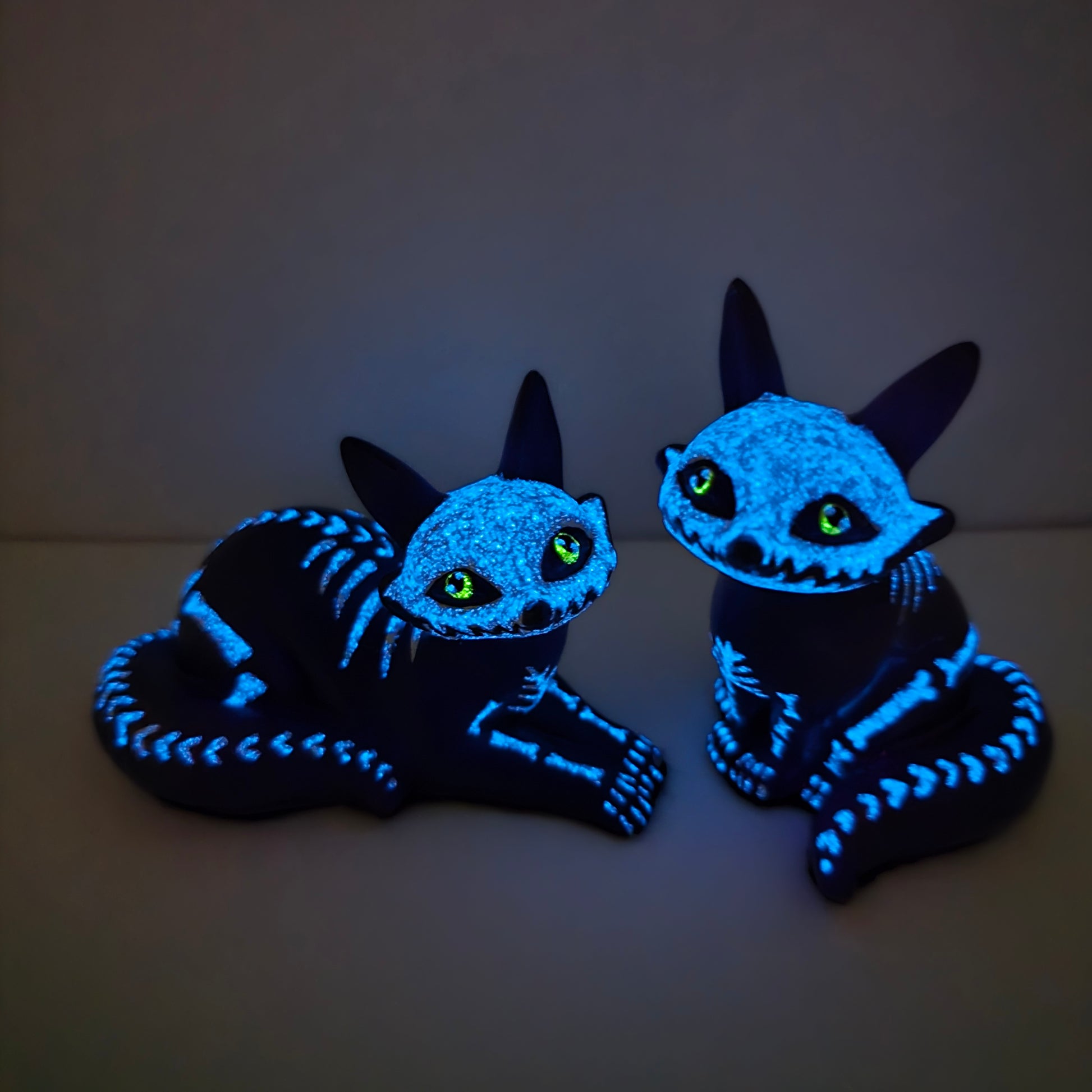 purple fox figures glowing in the dark, emitting blue where the white bones are and glowing yellow for their eye color