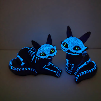 purple fox figures glowing in the dark, emitting blue where the white bones are and glowing yellow for their eye color