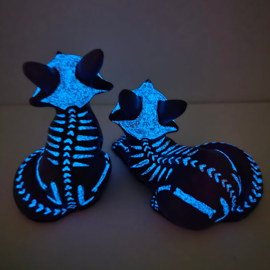 the back of the fox kit figures with their bone design glowing blue in the dark