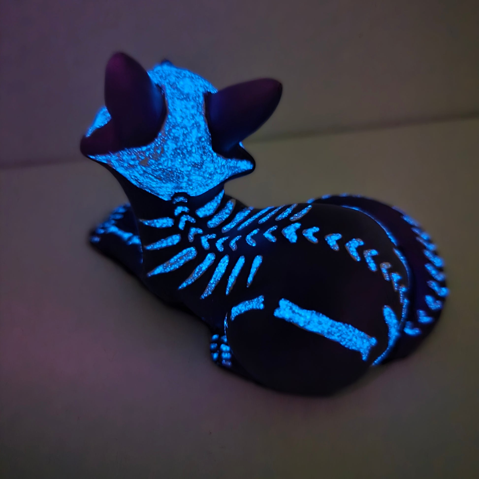 Purple fox kit figure with skeleton design and heart shaped spine bones glowing in the dark