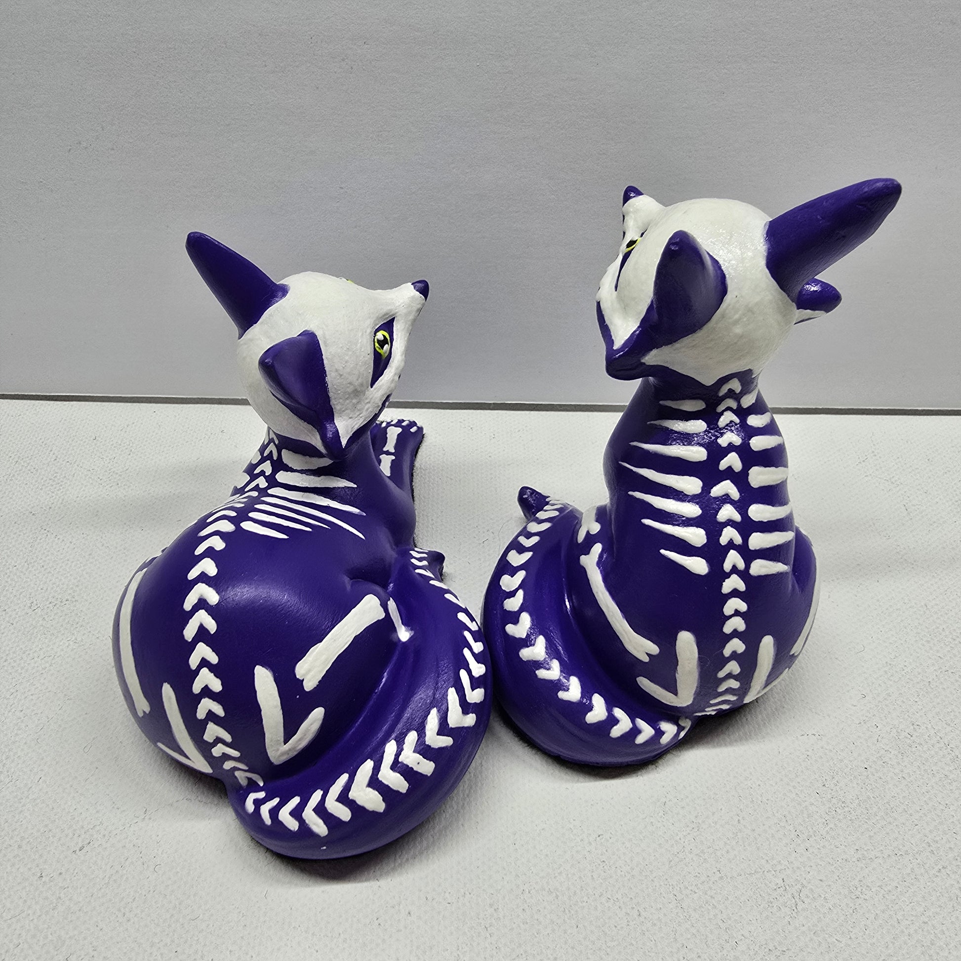 back of purple fox pup (kit) figures showing a heart shaped, herringbone Skeleton design