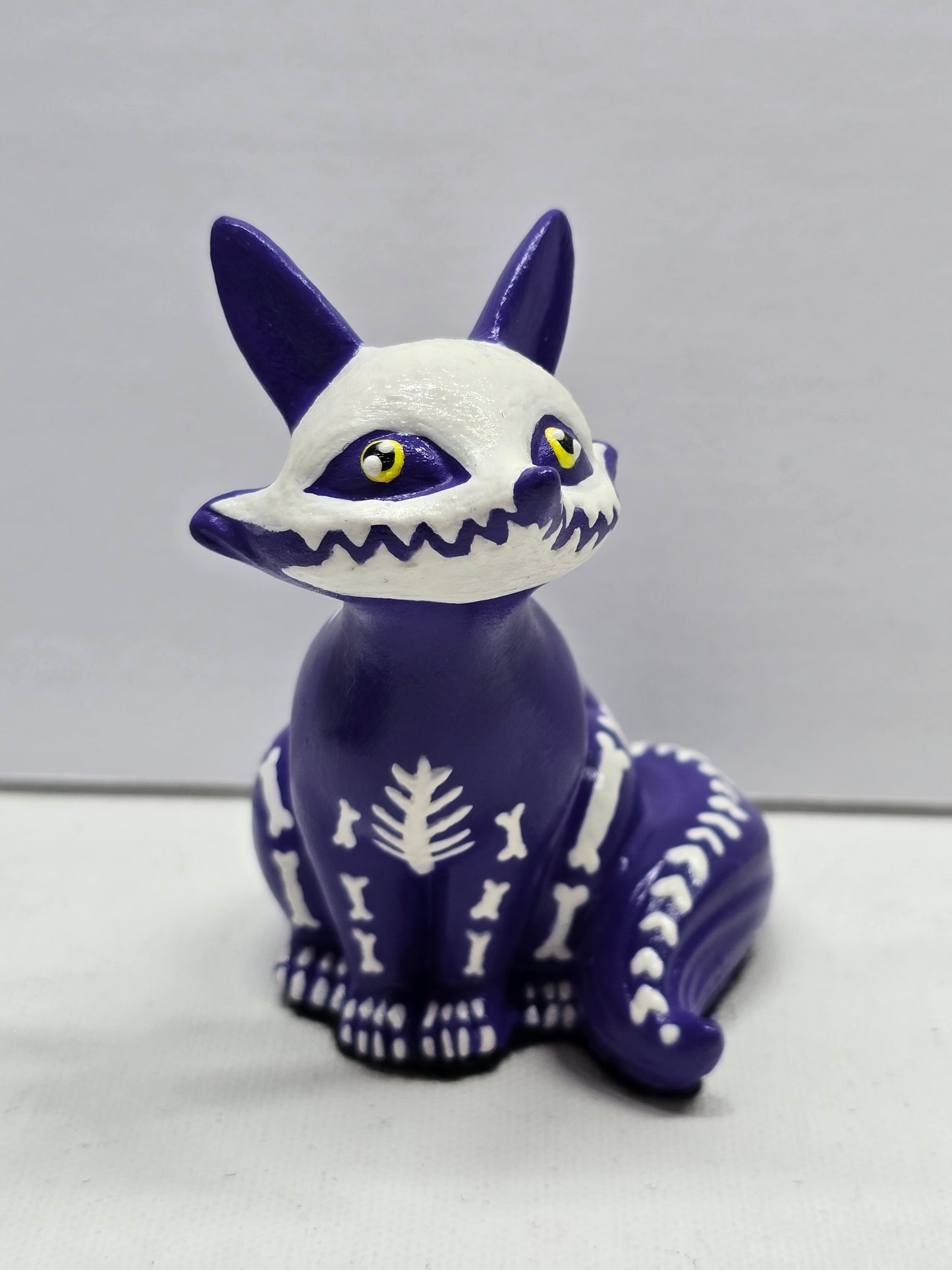 Cute halloween figure of a fox skeleton with yellow eyes