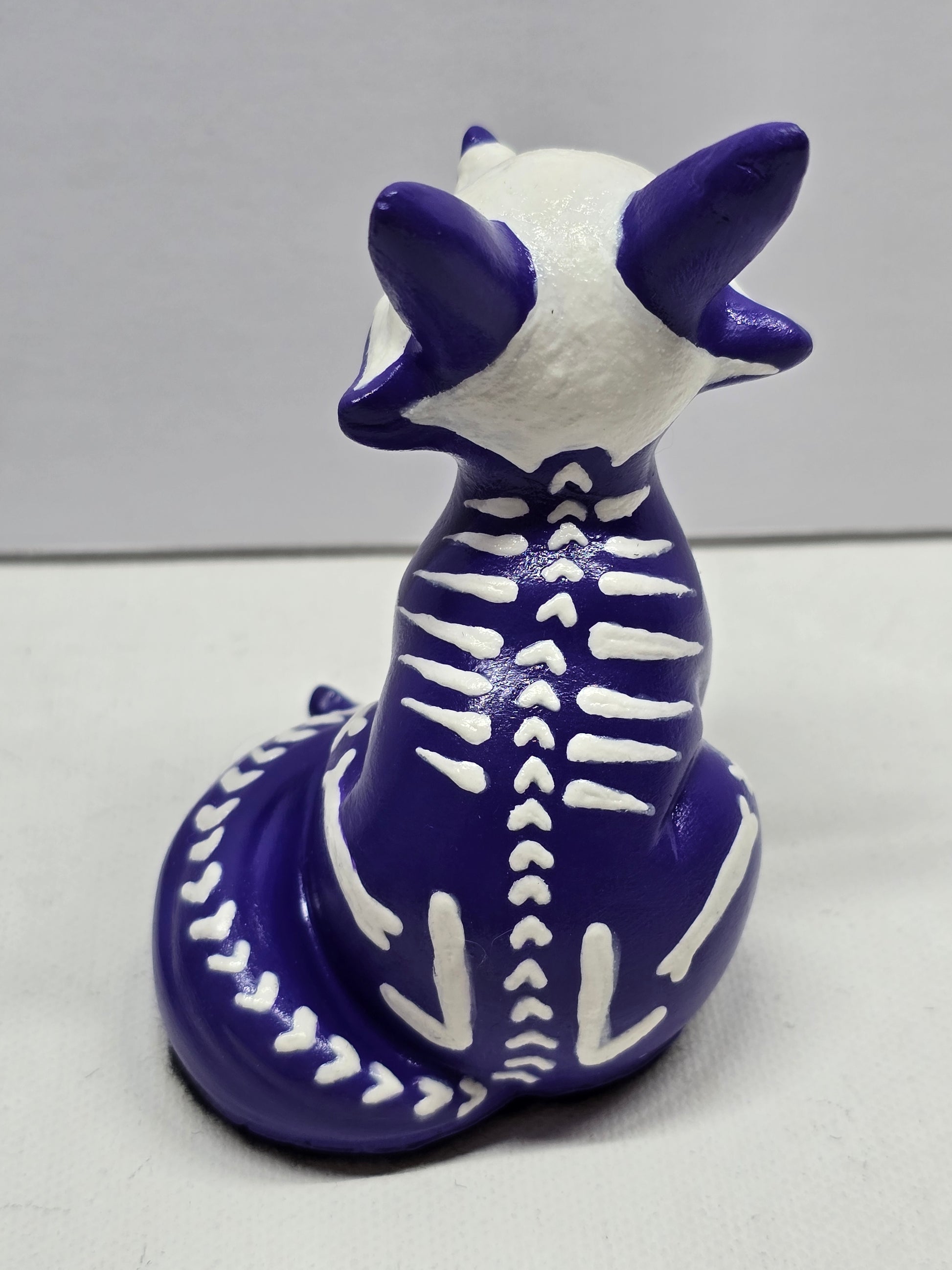 back of cute halloween fox figure skeleton, sitting 