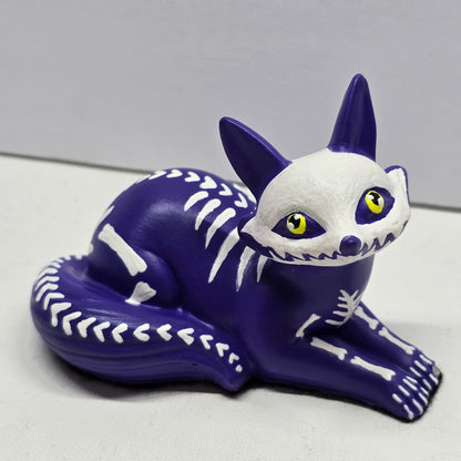halloween fox, painted purple with white bone designs and featuring bright yellow pleading eyes