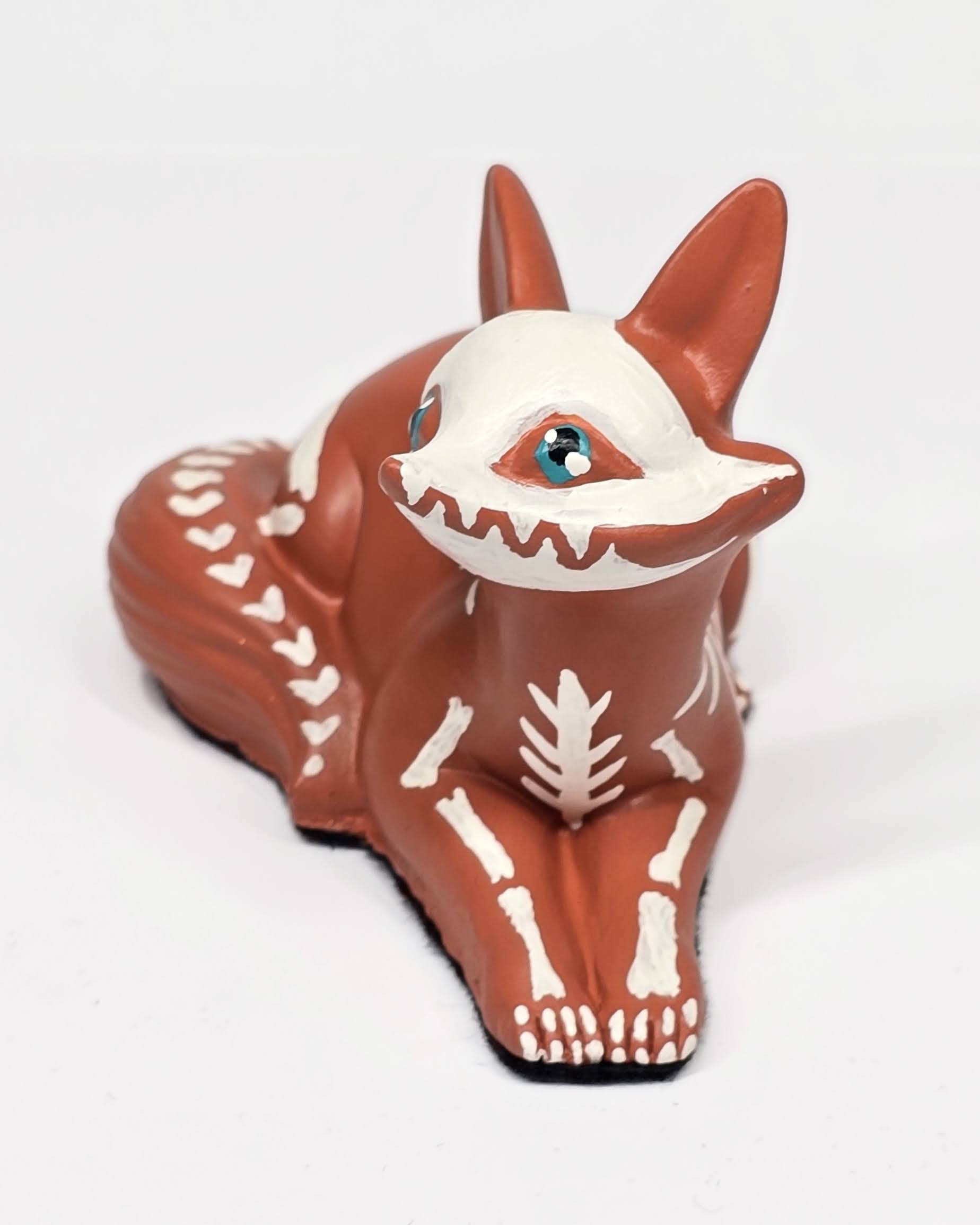 Sculpture of a fox with a skeleton design on a white background