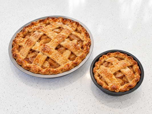 AI-generated example showing a full-size apple pie in the silver pan and a personal apple pie in the black pan.