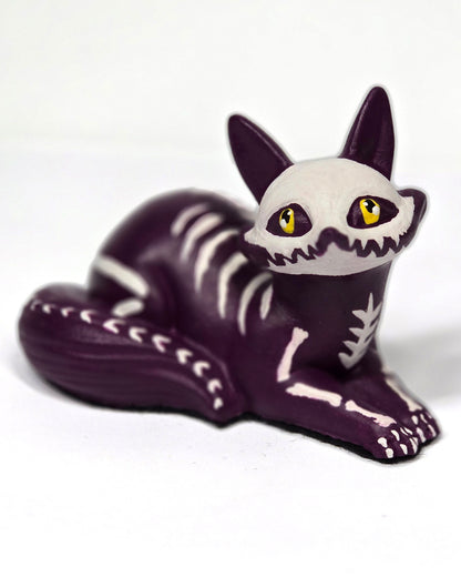 Skeletal fox kit puppy figurine with purple body and white skeleton pattern on a white background