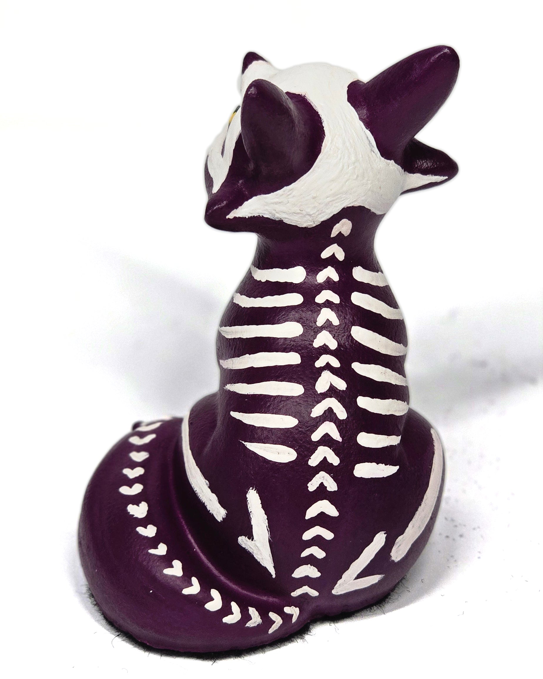 Skeletal fox figurine with purple and white colors on a white background